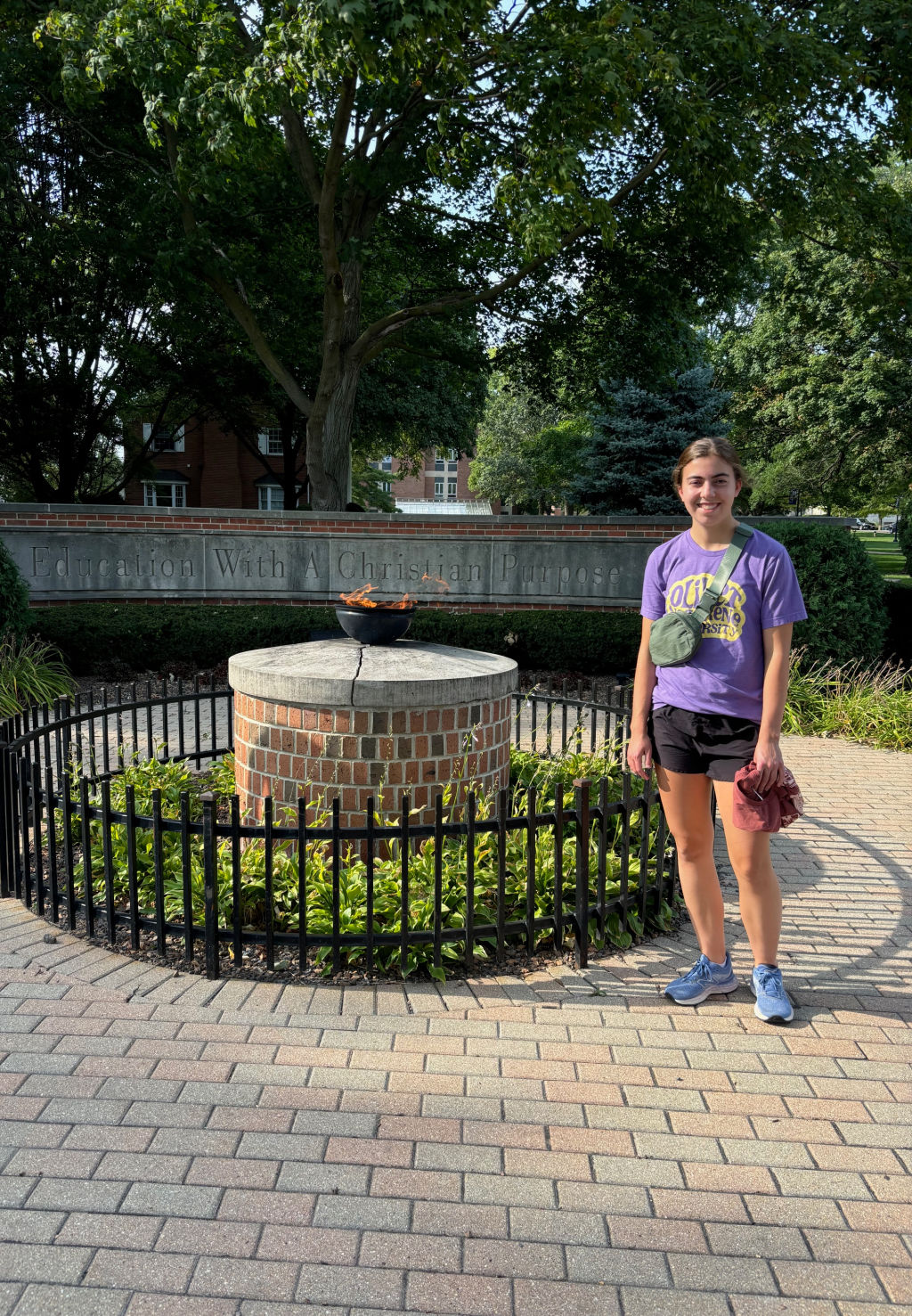 girl by flame on a college campus. 