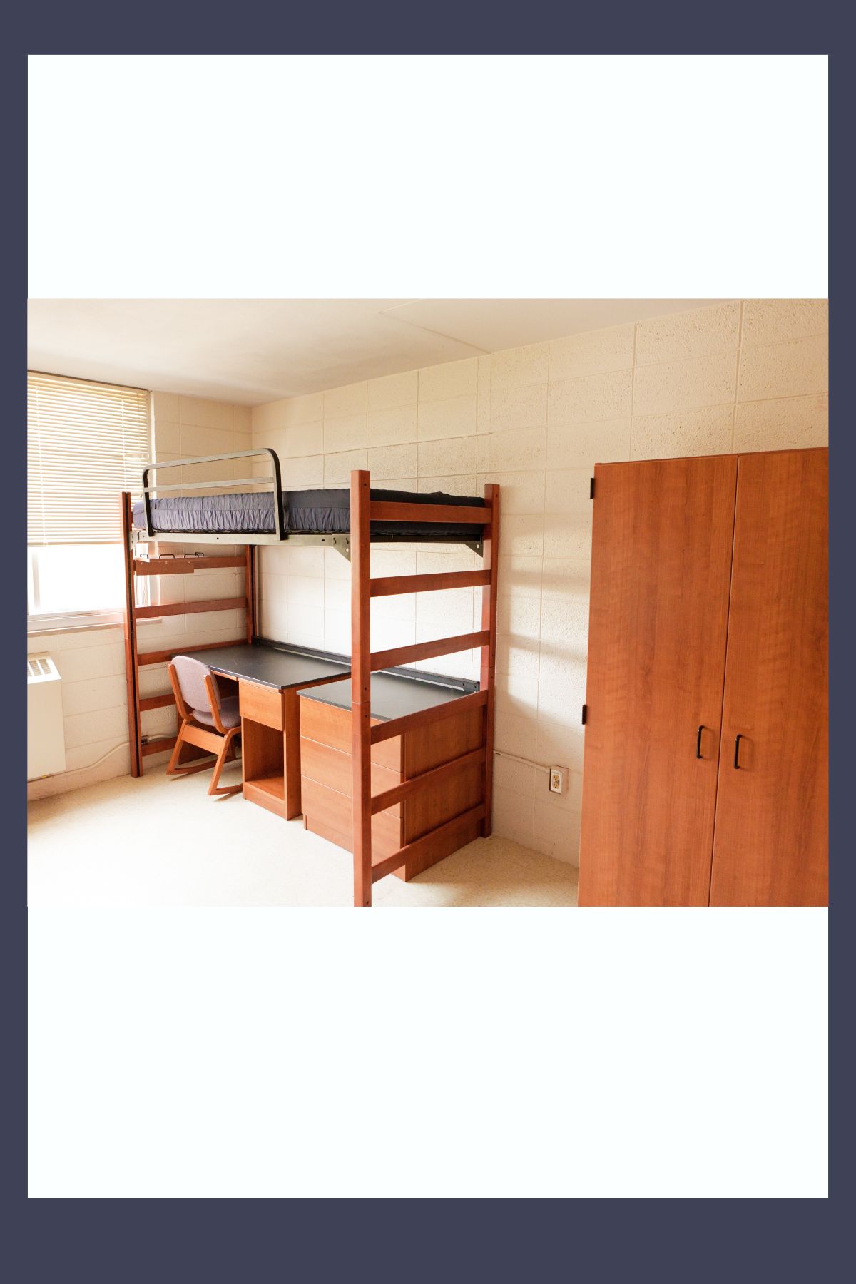 picture of a bed and desk in a dorm room. 