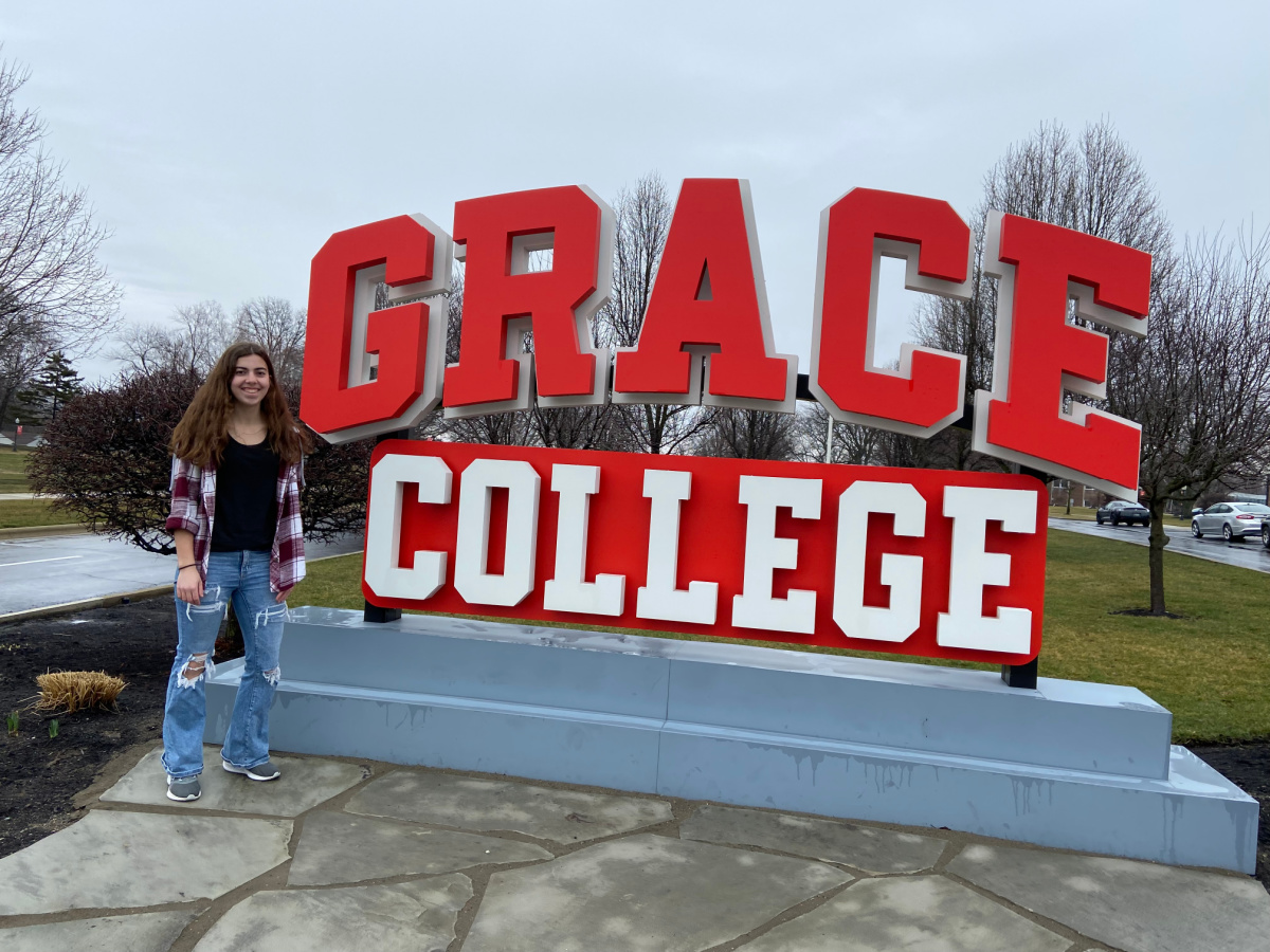 grace college sign with girl in front. 