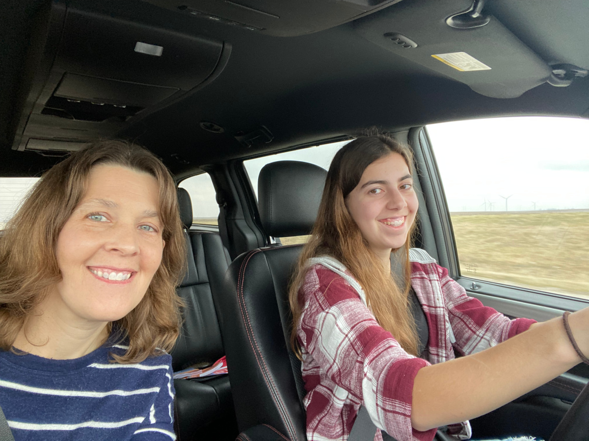 mother and daughter in a van driving. 